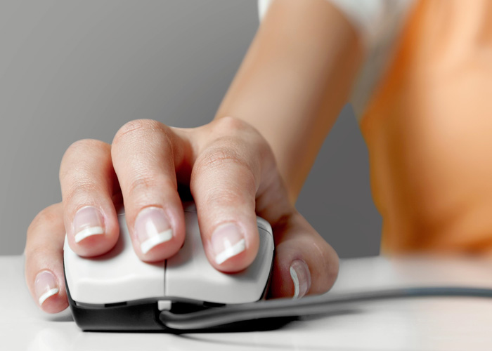 Woman's hand holding computer mouse